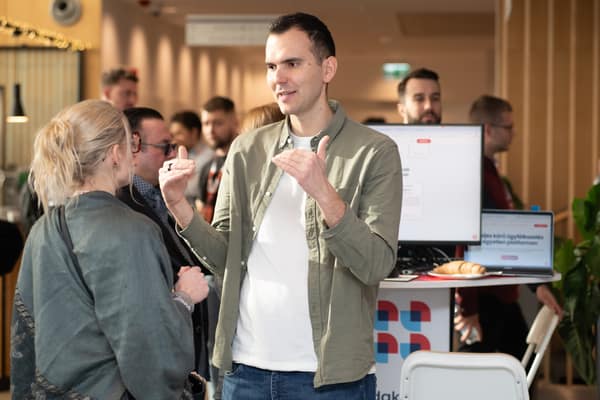 Attendees in conversation at a booth